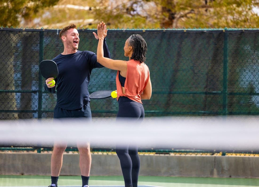 People High Fiving Playing Pickleball